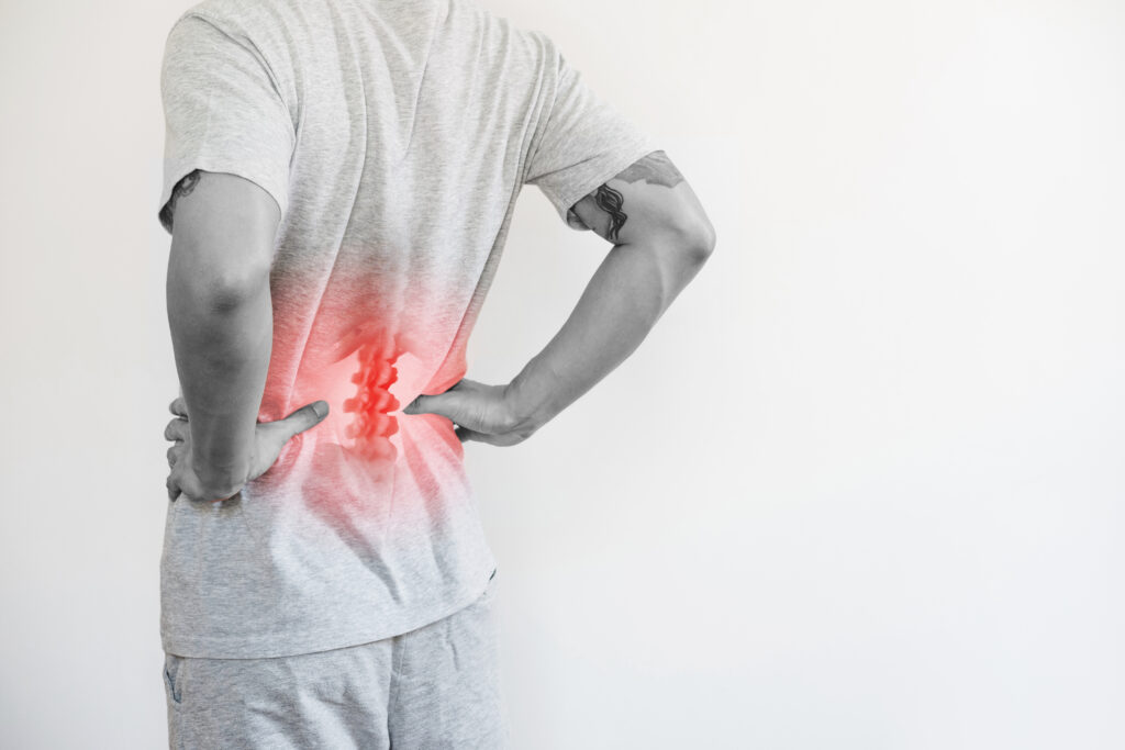 a man touching his lower back at pain point