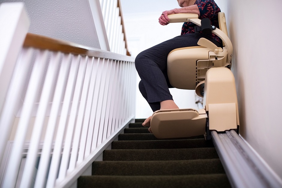 Woman riding a stair lift